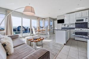 a kitchen and living room with a couch and a table at Pier View Suites - Townhouse B in Cayucos