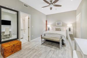 a bedroom with a bed and a mirror at Pier View Suites - Townhouse B in Cayucos