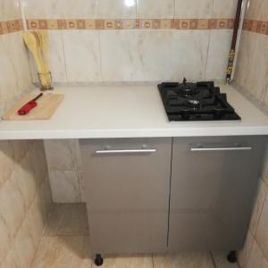 a kitchen with a stove and a counter top at Ruud Mall in Timişoara +3 photos