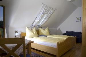 a bedroom with a bed with a canopy at Frühstückspension Kleinschuster in Burgau