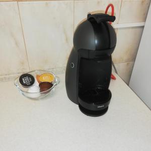 a coffee maker on a counter next to a bowl of eggs at Ruud Mall in Timişoara