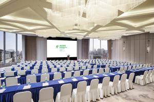 a large room with chairs and a projection screen at Holiday Inn Shanghai Huaxia, an IHG Hotel - overlooking city scenery at Sky View Restaurant in Shanghai