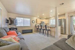 a living room with a couch and a kitchen at Beautiful St George Condo about 5 Mi to Downtown! in St. George