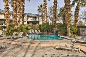 a swimming pool with chairs and palm trees at Beautiful St George Condo about 5 Mi to Downtown! in St. George