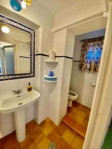 a bathroom with a sink and a mirror and a toilet at Villas2meet Can somni in Ses Salines +24 photos