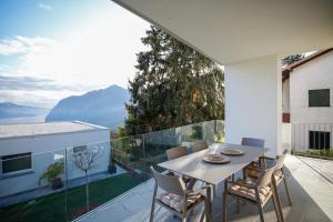 a dining room with a table and chairs on a balcony at IseoLakeRental - Seliera in Solto Collina