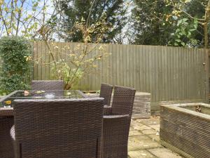 a patio with chairs and a table and a fence at Hollies Cottage 7 - Ukc4523 in Martock