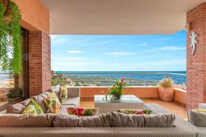 a living room with a couch and a view of the ocean at Villa Origami in Lloret de Mar