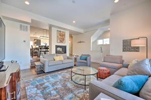 a living room with two couches and a table at Modern Townhome, Day Trip to Colorado Ski Resorts! in Louisville
