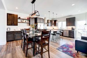 a kitchen and dining room with a table and chairs at Modern Townhome, Day Trip to Colorado Ski Resorts! in Louisville