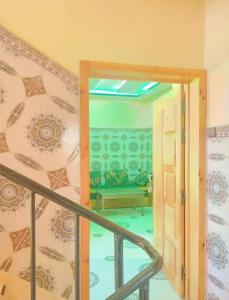 a hallway with a staircase and a room with a bench at RESIDENCE ANAS in Dakhla