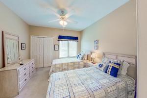 a bedroom with two beds and a ceiling fan at Tidewater Retreat in North Myrtle Beach