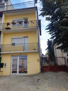 a building with a window with a picture of the eiffel tower at Apartman Novi Sad - Apartment Novi Sad in Sremska Kamenica