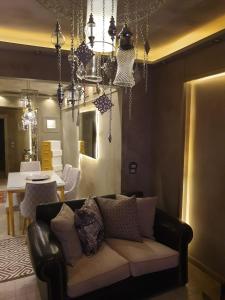 a living room with a couch and a dining room at شقق للايجار اليومي المهندسين - الدقي -الزمالك in Cairo