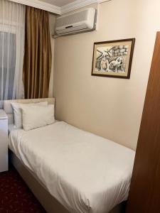 Postel nebo postele na pokoji v ubytování Paris Hotel
