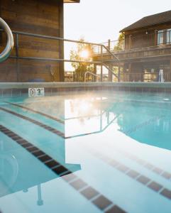 an empty swimming pool with the sun setting at Teton Valley Resort in Victor