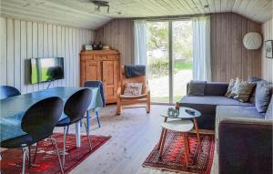 a living room with a couch and a table at Stunning Home In Anholt With 3 Bedrooms in Anholt