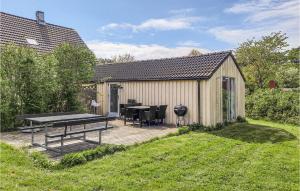 a backyard with a table and a picnic table on a deck at Stunning Home In Anholt With 3 Bedrooms in Anholt