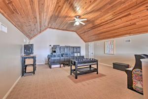 a living room with a ceiling fan and a table at Lakefront Retreat with Views, Near Mammoth Cave! in Cub Run