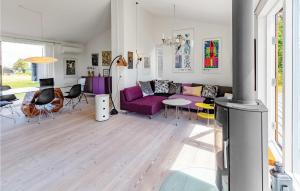 a living room with a purple couch and a table at Awesome Home In Kalundborg With Kitchen in Kalundborg