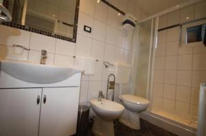 a bathroom with a sink and a toilet at Apartment Poropat in Poreč +31 photos