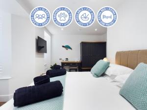 a bedroom with a bed and blue and white plates on the wall at Driftwood Boutique Guest House in Rhosneigr