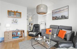 a living room with a couch and a table at Nice Apartment In Allinge With Wifi in Allinge