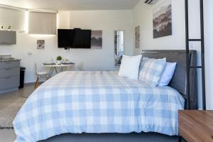 a bedroom with a blue and white bed and a table at Aquaville Dorado Moderna A Studio 7 in Dorado