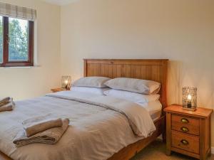 a bedroom with a large bed with two night stands at Park Lane in Auldgirth