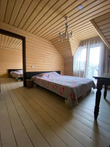 a bedroom with a bed in a wooden room at Royal Yablunytsya in Yablunytsya
