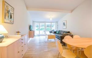 uma sala de estar com uma mesa e um sofá em Lovely Apartment In Nex With Sauna em Neksø