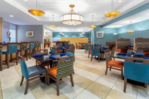 a dining room with tables and chairs at Holiday Inn Winter Haven, an IHG Hotel in Winter Haven