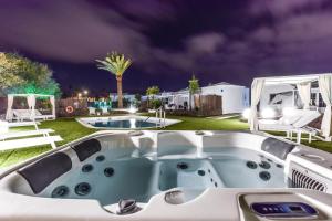 a jacuzzi in a backyard at night at VILLAS NEW LANZASUITES PLUS in Playa Blanca +65 photos