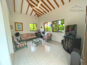 a living room filled with furniture and a tv at Casa de Campo en Girardot in Ricaurte