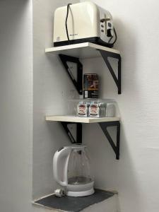 a shelf with a blender and a toaster on a wall at Mini Appartement neben Theater in Duisburg