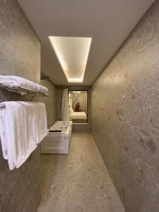 uma casa de banho com lavatório e toalhas brancas em فندق جولدن توليب أبها - GOLDEN TULIP ABHA HOTEl em Abha