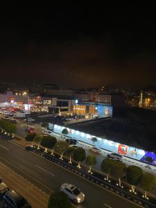 a view of a city at night with a street at فندق جولدن توليب أبها - GOLDEN TULIP ABHA HOTEl in Abha