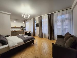 a bedroom with a bed and a couch at Old Gold Anteon in Tbilisi City