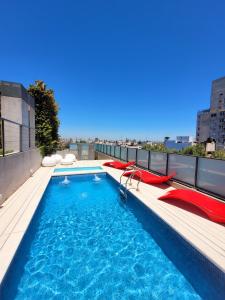 a swimming pool on the roof of a building at Pleno Palermo Soho in Buenos Aires