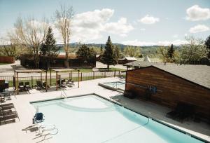 a large swimming pool with a brick building at Teton Valley Resort in Victor