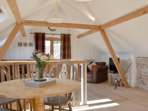 a dining room and living room with a table at The Hay Barn - Ukc4135 in Arlingham