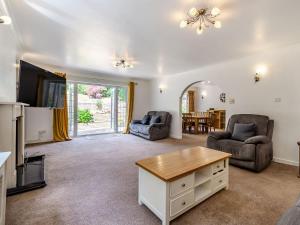 a living room with a couch and a table at Greenacre in Fawkham