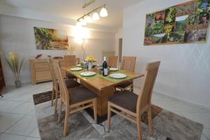 a dining room with a wooden table and chairs at Zauber der Pfalz in Römerberg