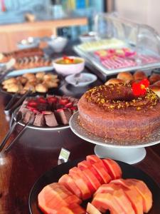 a table topped with lots of different types of food at Vila Toá in Alto Paraíso de Goiás