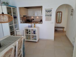 a kitchen with white cabinets and a tile floor at la ventana al mar in Jávea