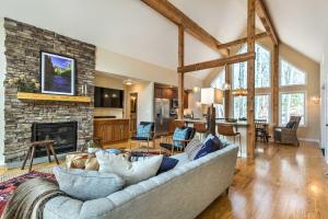 a living room with a couch and a fireplace at Designer Home with Fire Pit about 70 Steps to Slopes! in Wintergreen