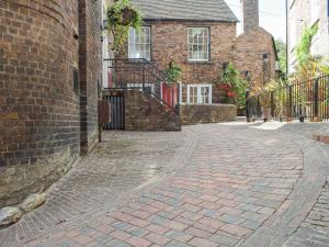 an empty brick street in front of a brick building at 1 Severn Bank in Ironbridge