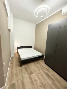 a room with a bed in the corner of a room at Odesa city center in Odesa