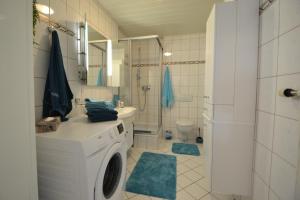 a bathroom with a washing machine and a shower at Ferienwohnung Zauber der Pfalz nahe Speyer in Römerberg