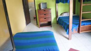 a bedroom with a bed and a tv on a dresser at Zumag Sisa in Tena